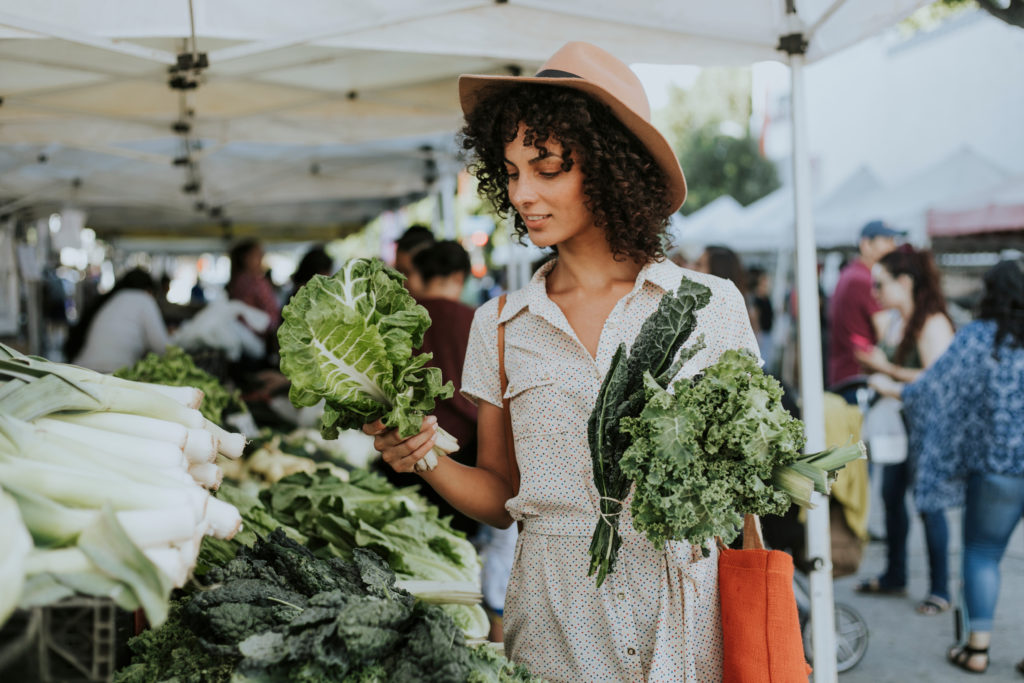 Eco conscious woman shopping for organic food at a local farmers market