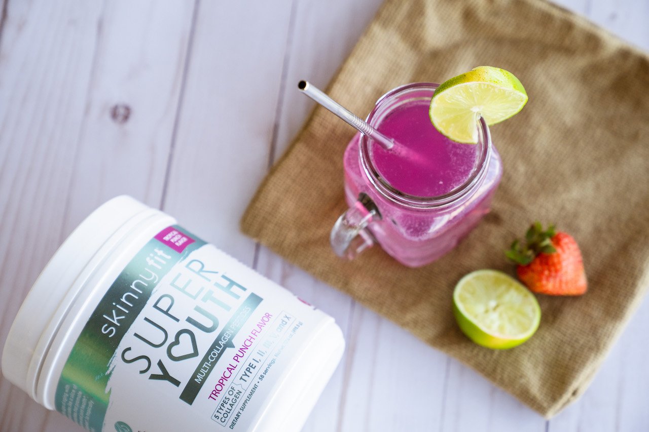 Tropical coconut water beside a container of Super Youth Tropical Punch collagen peptides.