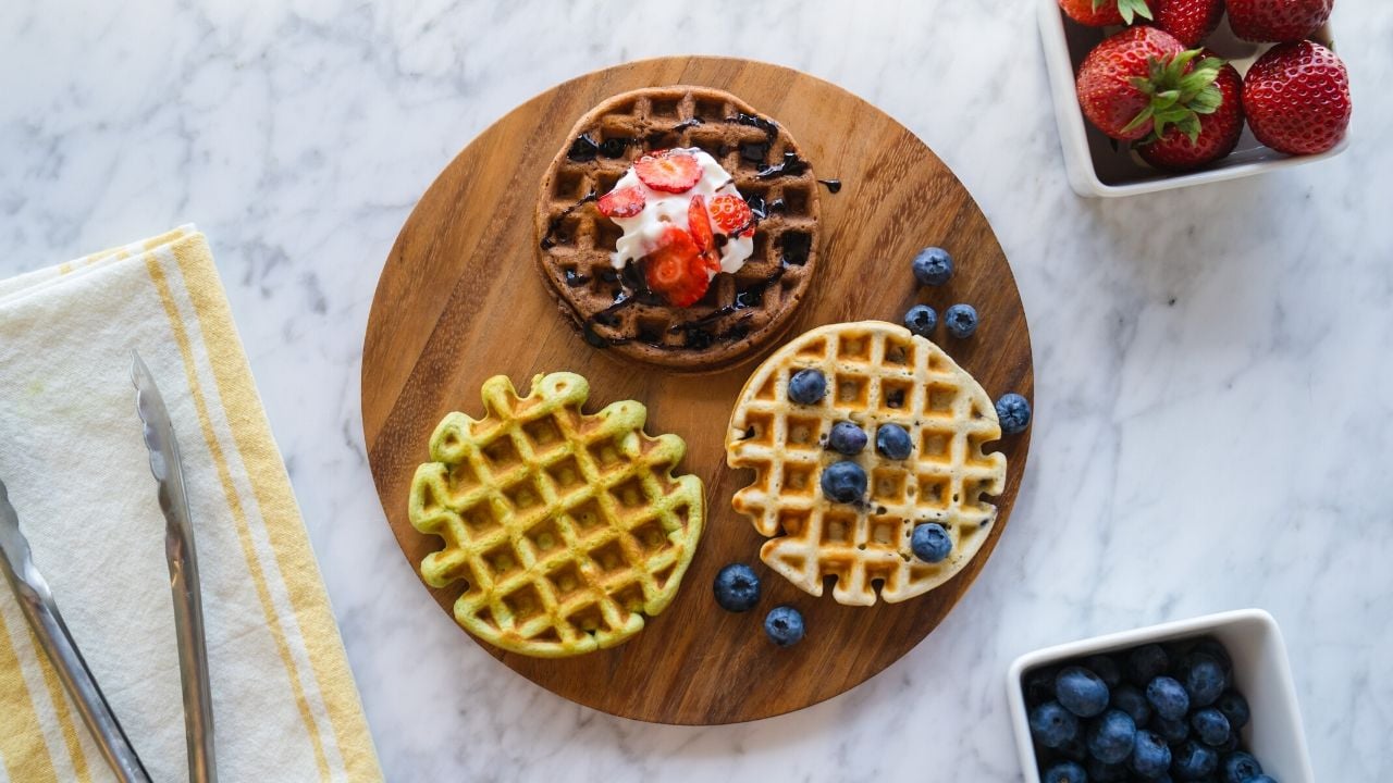 Homemade waffles in different flavors with blueberries and strawberries