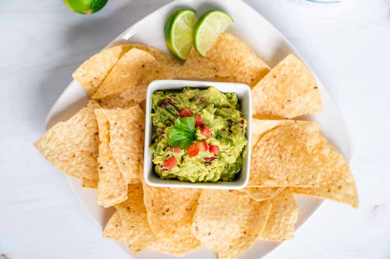 Healthy Guacamole Recipe in dipping bowl with chips