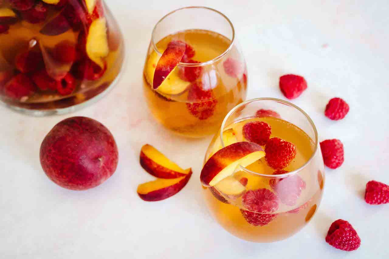 Rose sangria with peaches, raspberries, and SkinnyFit Super Youth Peach Mango Collagen