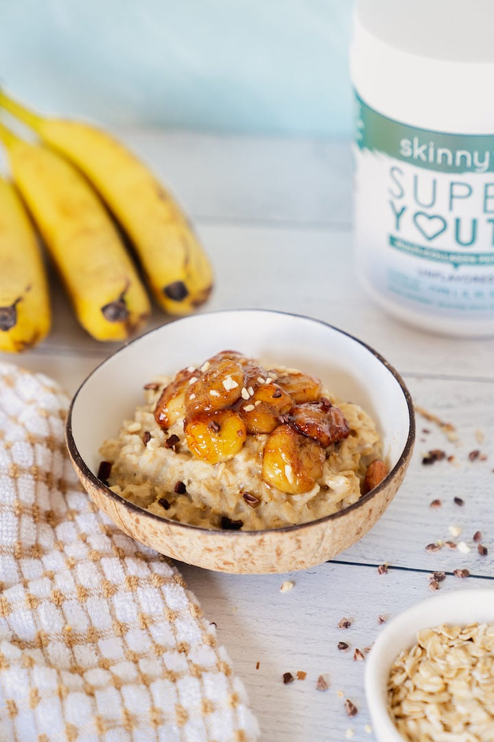SkinnyFit Bananas Foster Oatmeal With Super Youth Collagen in the background