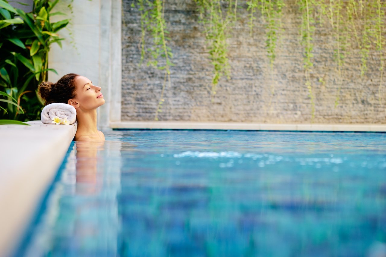 Woman relaxing in a prestine pool.