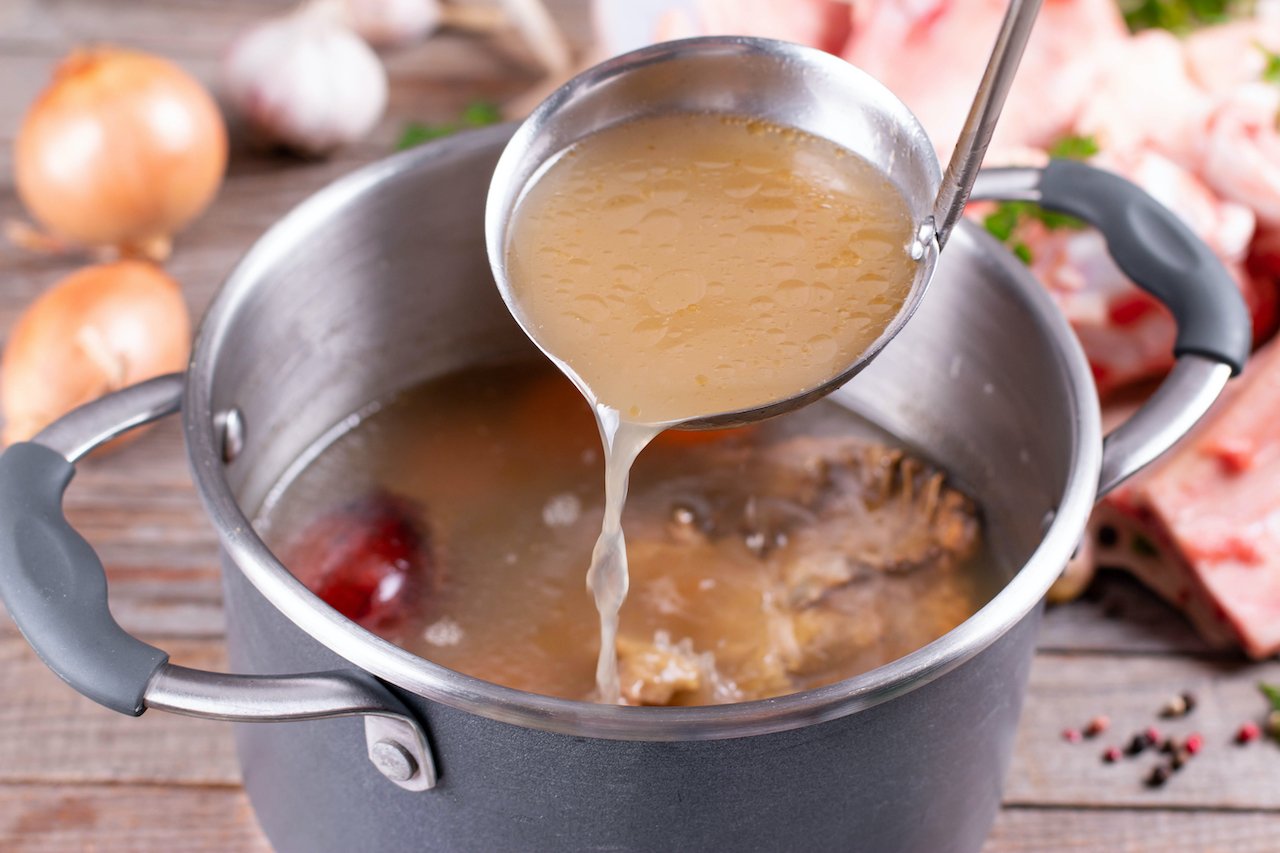 A cooking pot of bone broth collagen. Unlike Super Youth collagen peptides, the only way to get collagen benefits from bone broth is to slow cook it yourself.