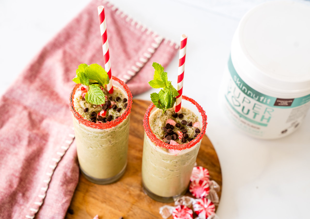 Mint Chocolate Shake glasses on a serving platter beside a jar of SkinnyFit Super Youth Chocolate Cake Collagen Peptides